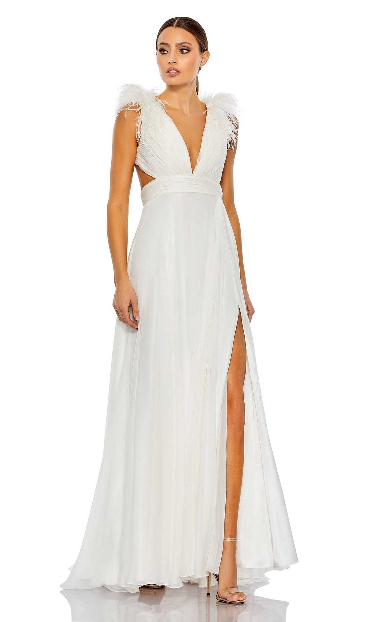 A woman stands against a white background wearing the Mac Duggal 68113 Feather-Trim Long Formal Dress, featuring feathered shoulder accents, a deep V-neckline, high slit, and open sides.